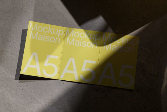 Yellow A5 paper brochure mockup in natural sunlight, perfect for designers to display graphics and fonts.