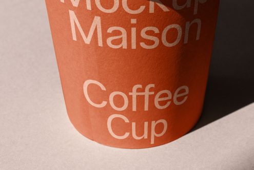 Realistic coffee cup mockup with typographic design, showcasing shadow play and texture details, perfect for presentations and branding.