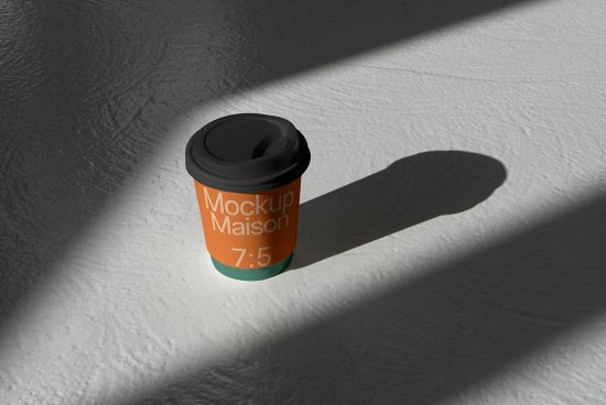Realistic coffee cup mockup on textured shadowed surface, ideal for presenting branding designs to clients, editable template for designers.