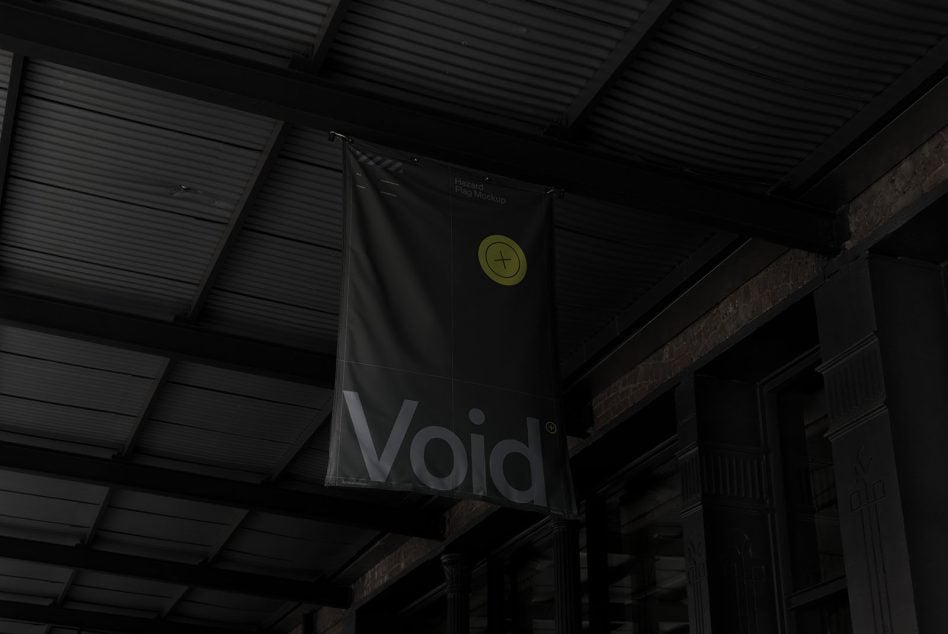 Black flag mockup hanging in dark industrial warehouse with yellow badge logo