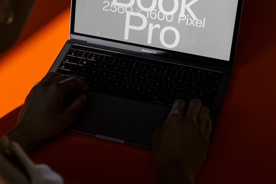 Laptop mockup with text overlay on screen, person working, designer workspace, modern device presentation, digital asset creation.