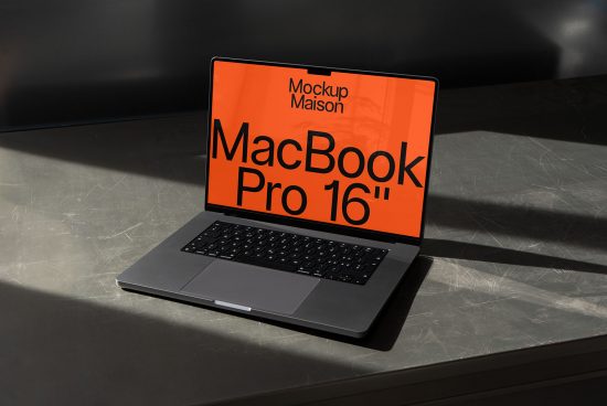 Laptop mockup on shadowed surface featuring MacBook Pro 16-inch screen for digital asset design display, ideal for presentations and web templates.