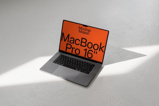 Laptop mockup on white surface with shadow, MacBook Pro 16-inch display for digital designs, realistic template for website graphics.