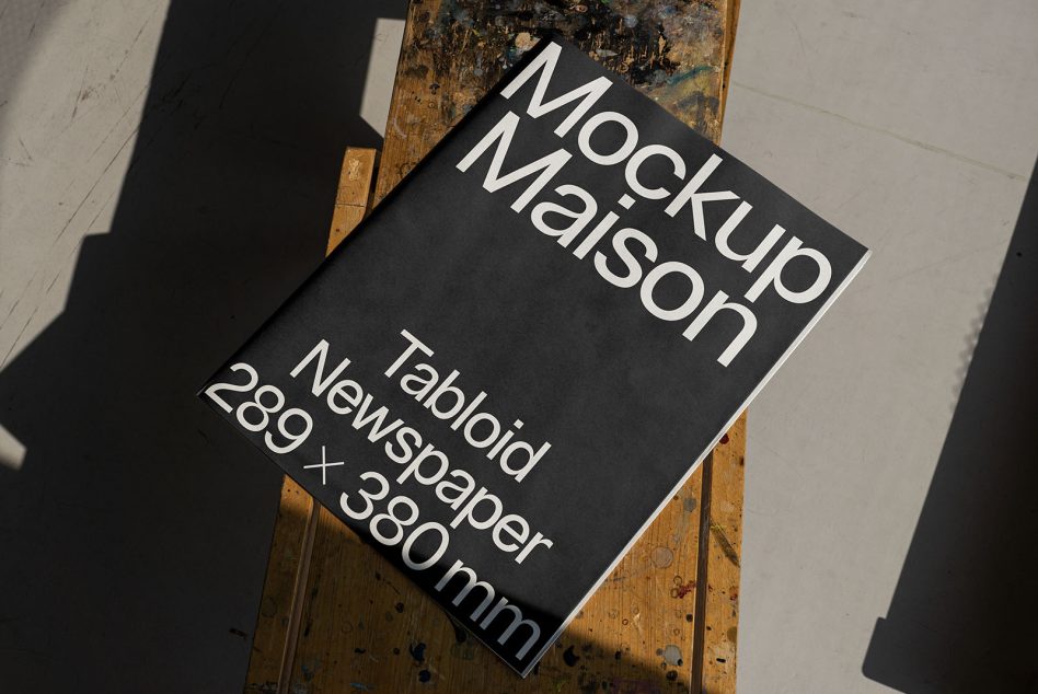 Mockup Maison tabloid newspaper template on wooden table with shadows for graphic design presentations, 289 x 380mm, realistic mockups category.