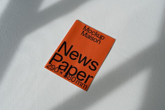 Orange newspaper mockup on textured background with natural shadows, design presentation, print template, 290x380mm dimensions.