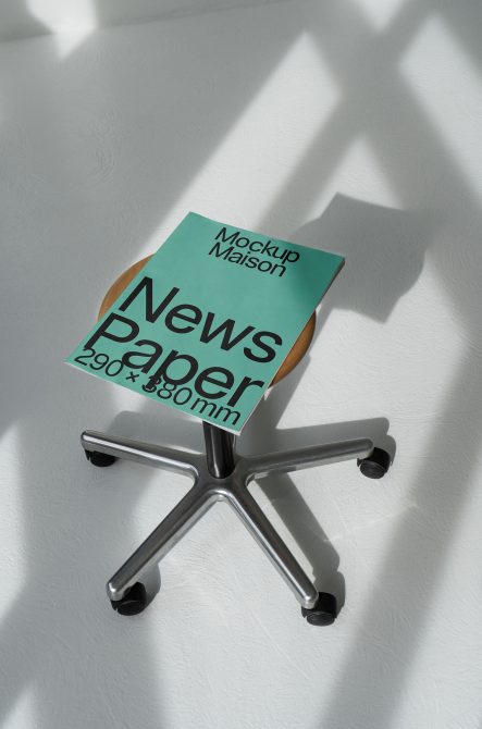 Elegant newspaper mockup on office chair showcasing clean design, ideal for presentation templates, graphic design resources, shadow play.