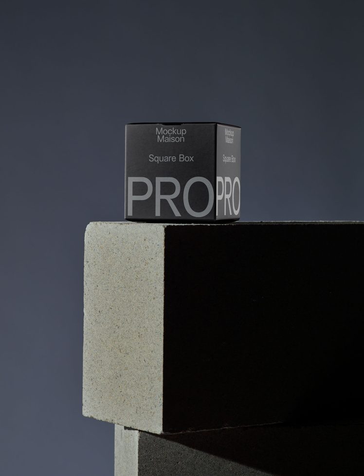 Square box package mockup design on textured platform with shadow, minimalist style for product presentation.