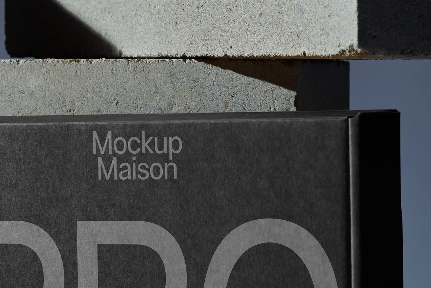 Close-up of a sophisticated black box mockup with elegant typography showcasing design, ideal for product packaging presentation.