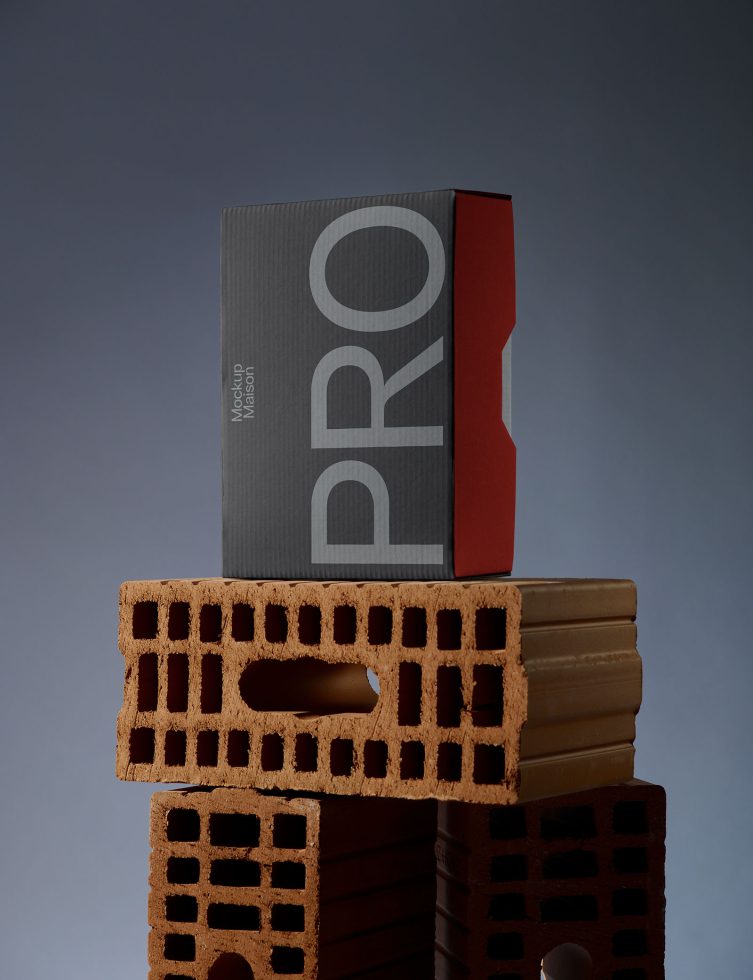 Professional packaging mockup featuring a minimalist box on a stack of bricks with a sleek design ideal for presenting branding projects to clients.