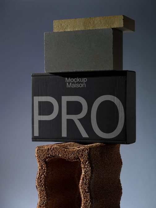 Minimalist product box mockup on a textured cylinder with elegant stone slabs for design presentation and portfolio showcase.