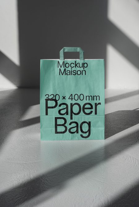 Elegant paper bag mockup standing on a textured surface with strong shadows, ideal for presentations and branding projects in design.