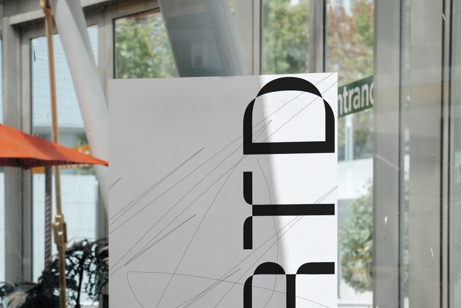 Window decal mockup on glass with bold black letters, diagonal line texture overlay