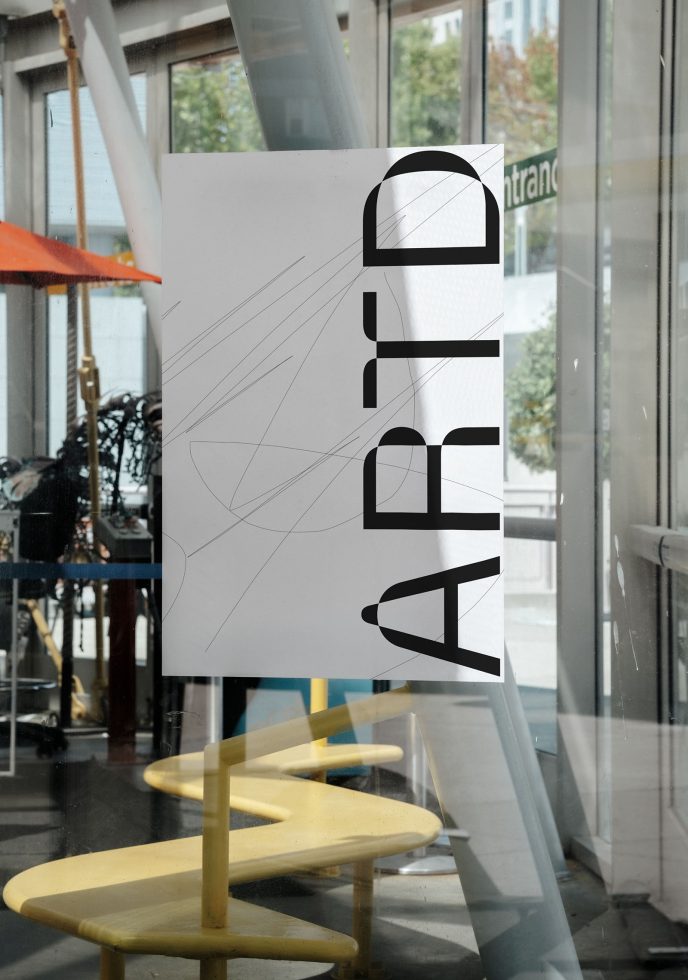 Urban poster mockup on glass window in cafe setting with yellow stools, showcasing modern typography design for creative graphic assets.