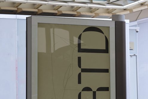 Close-up of a modern poster mockup in an urban setting, showcasing bold typography design, ideal for designers.