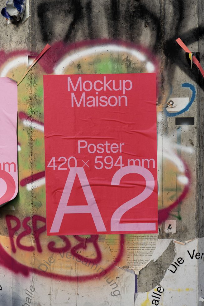 A2 poster mockup on concrete wall with graffiti and torn posters. Urban presentation for design templates, graphic display, and mockups.