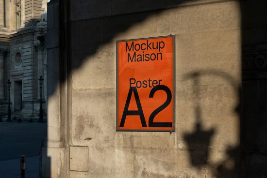 Orange A2 poster mockup on outdoor wall with shadows, ideal for presentation in graphic design, advertising, and urban mockups.