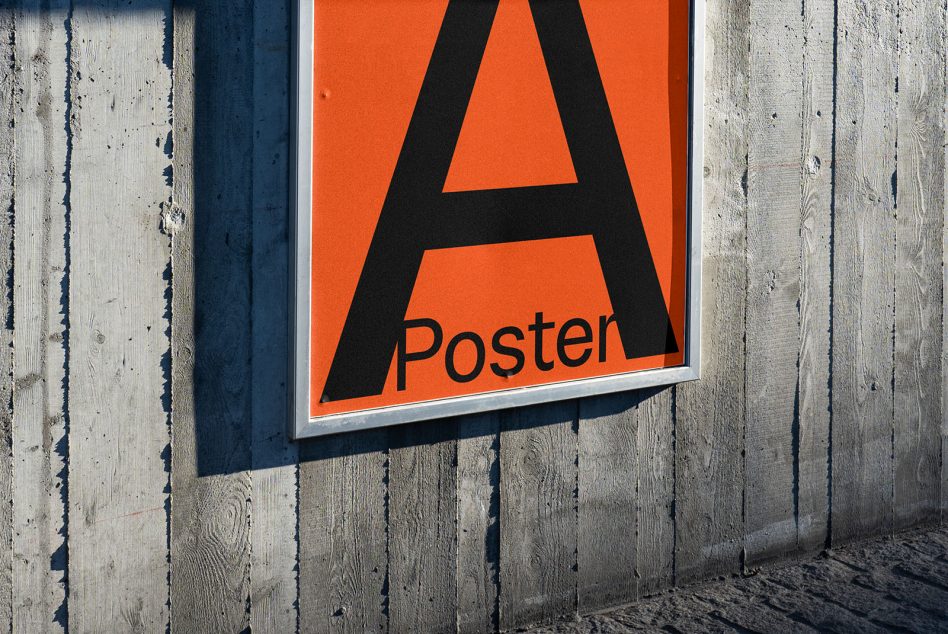 Close up of orange poster with bold black A letter on wooden surface backdrop