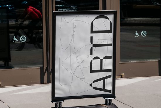 A sidewalk signboard mockup featuring abstract graphics and bold typography, ideal for presenting outdoor advertising designs to clients.