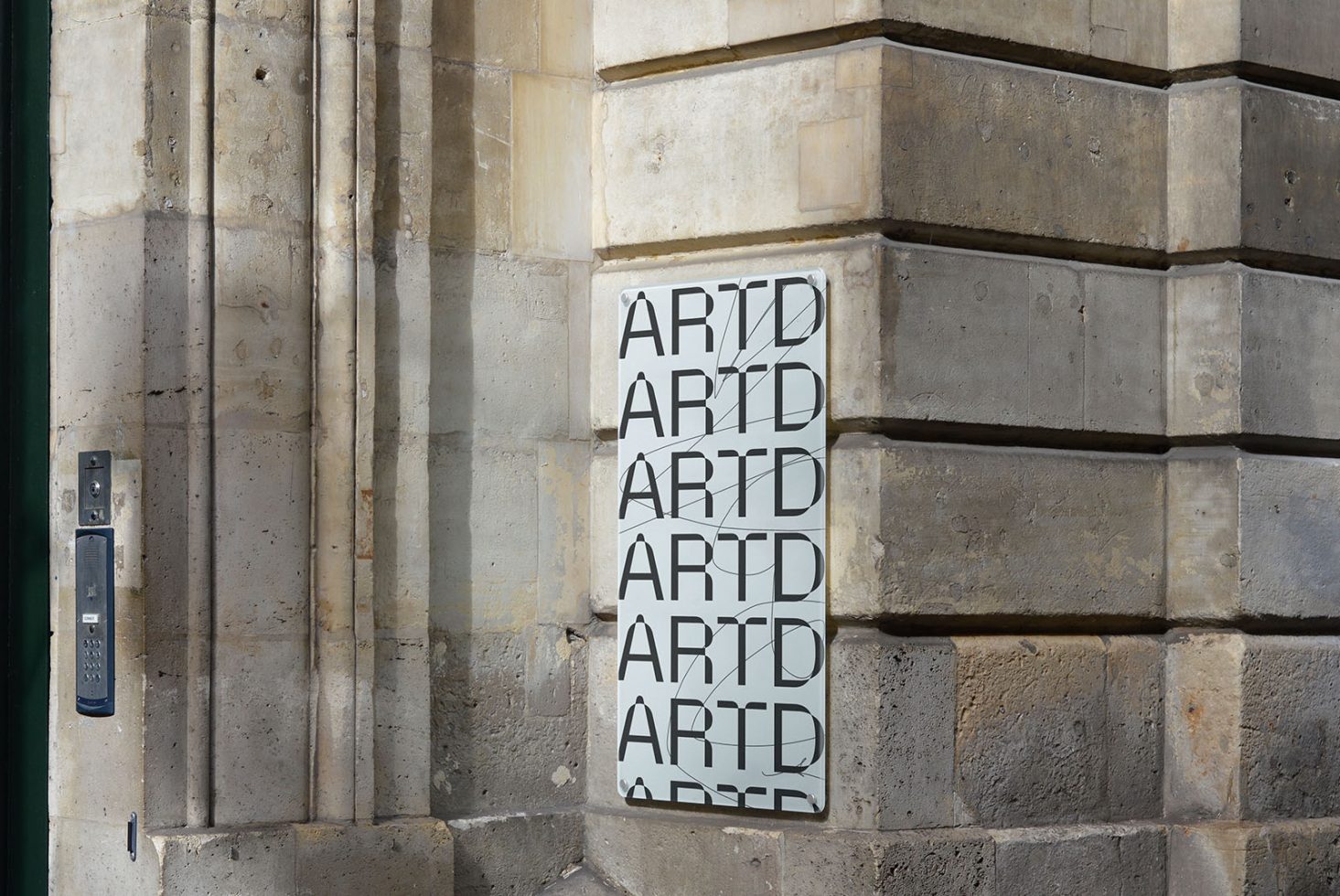 Urban street with bold typography poster mockup on stone wall, showcasing modern font design for graphic assets.