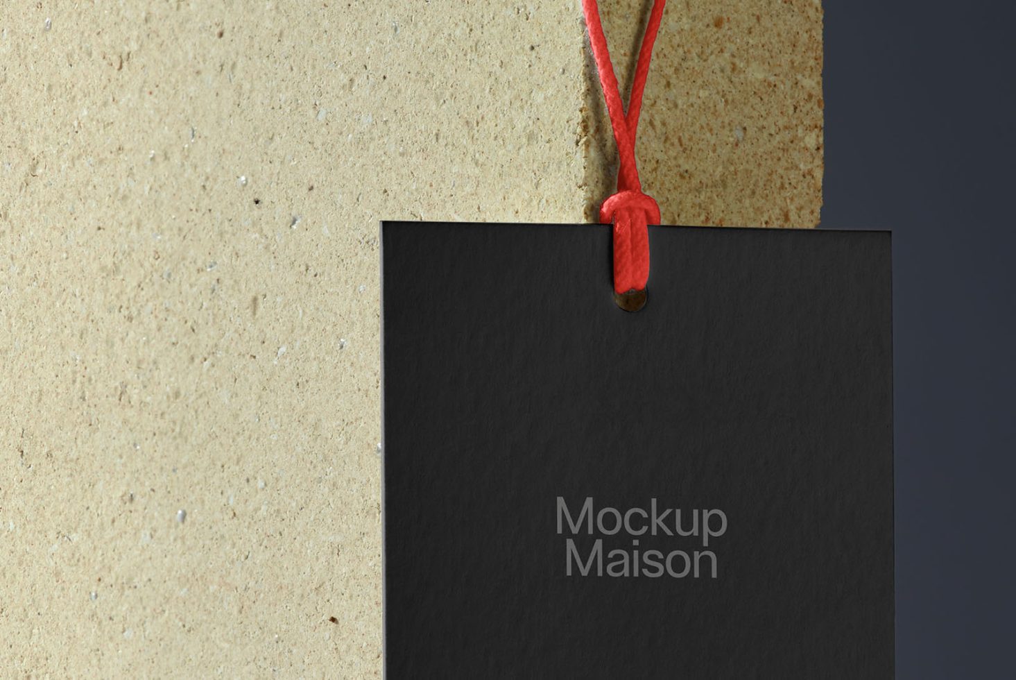 Black tag mockup with red string against textured background, ideal for branding presentation in graphic design.