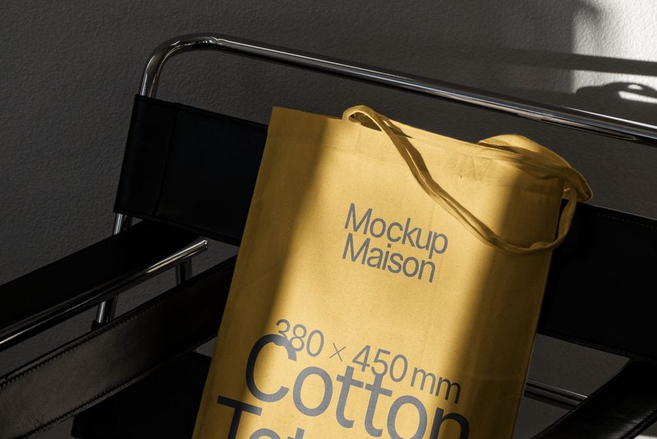 Full shot gold tote bag mockup on minimalist black metal display stand