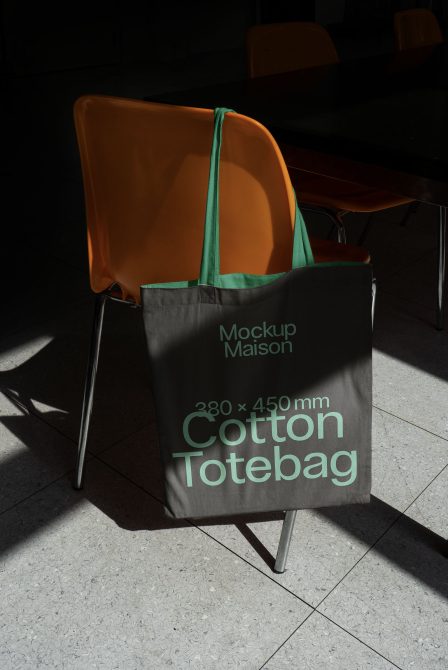 Professional mockup of cotton tote bag on a chair, realistic textures, highlighted product design, ideal for graphic presentations and portfolios.