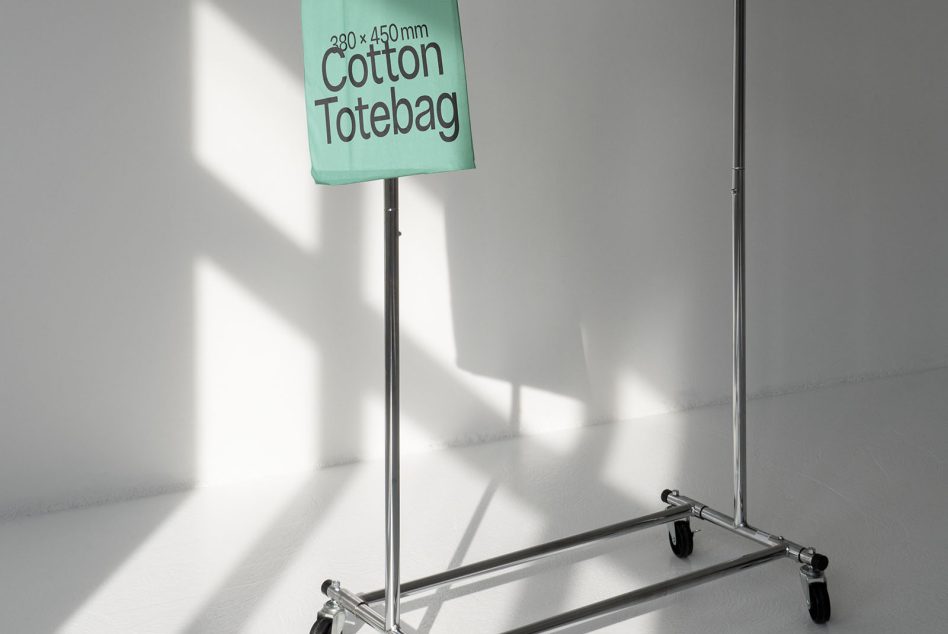 Mint green cotton bag hanging from tall rolling garment rack