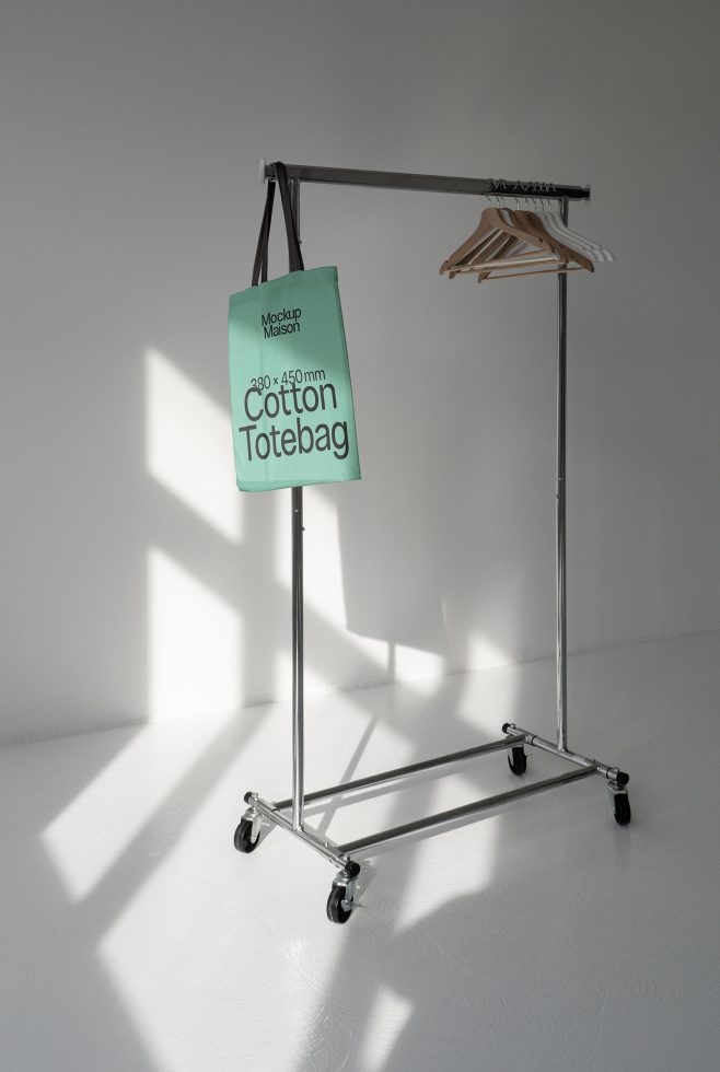 Minimalist tote bag mockup on metal stand with shadows, showcasing design space for branding in a clean, modern setting ideal for designers.