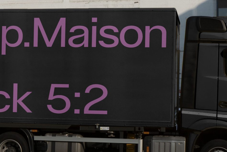 Side view of a delivery truck mockup with purple text graphics for branding and advertising design showcase.