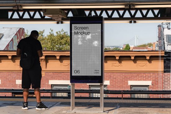 Outdoor advertising screen mockup at a train station with a man observing, clear sky, urban backdrop, digital asset for designers.