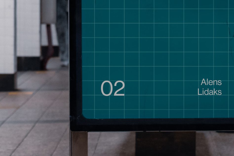 Teal grid screen display in blurred indoor corridor with tiled walls
