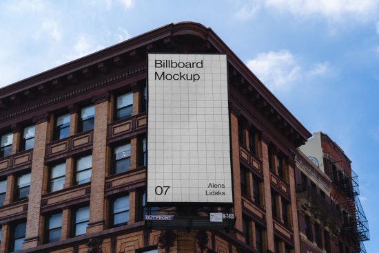 Urban billboard mockup on a classic brick building for outdoor advertising, clear blue sky, realistic cityscape design asset.