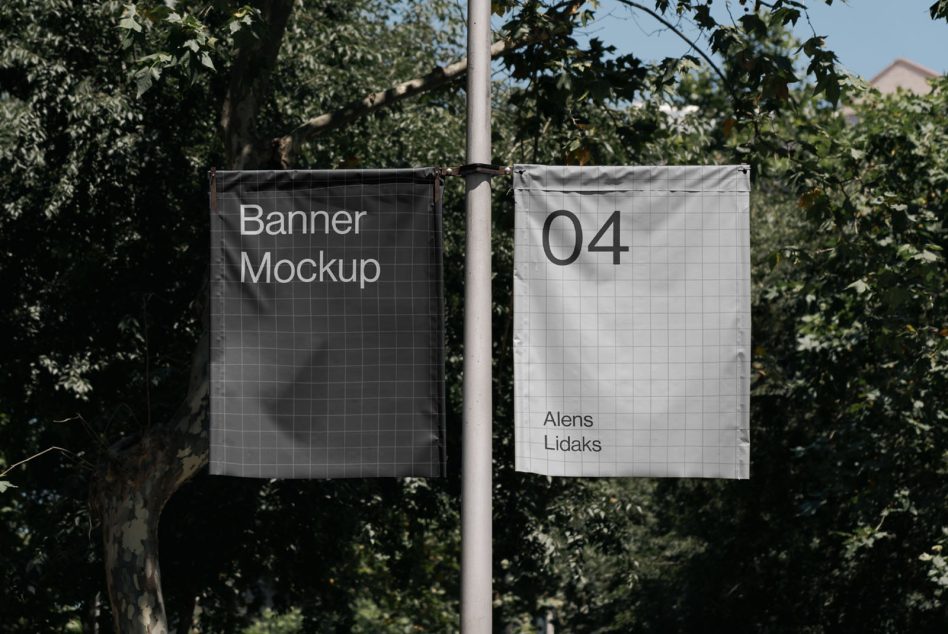 Outdoor hanging banner mockups on a pole with trees in the background, displaying design placeholders for advertising.