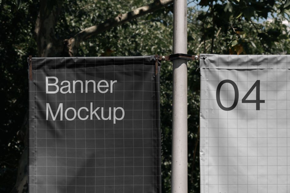 Outdoor banner mockup on metal poles with trees in the background, ideal for designers to display branding work.