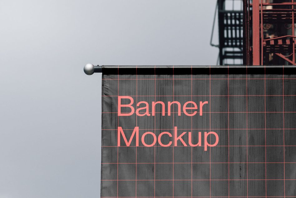 Outdoor advertising banner mockup on building side with overcast sky, showcasing design space for graphics and text.