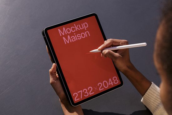 Person holding tablet with stylus showcasing high-resolution modern mockup for designers, ideal for presentations and portfolios.