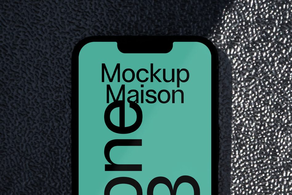 Smartphone screen mockup with turquoise background featuring bold typography for design presentation, displayed on a textured surface for designers.