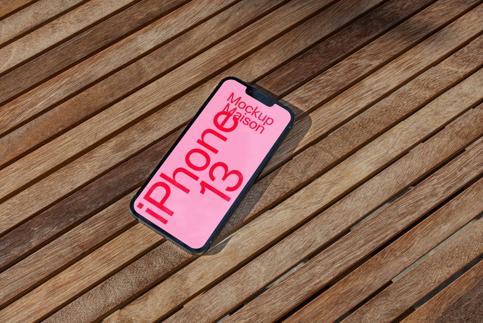 Smartphone mockup on wooden slats with pink screen for design presentations, device mockup, digital asset for designers, iPhone 13 graphic.