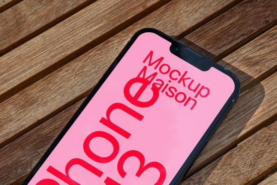 Smartphone mockup on wooden surface with clear screen for design presentation, ideal for digital mockups, device templates, and designer assets.