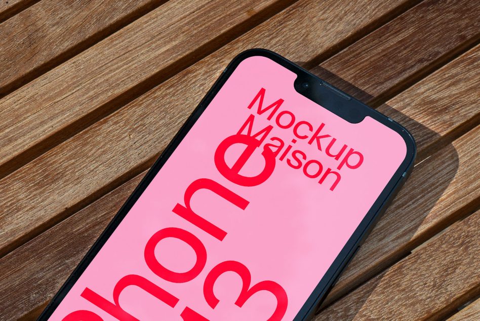 Smartphone mockup on wooden surface with clear screen for design presentation, ideal for digital mockups, device templates, and designer assets.