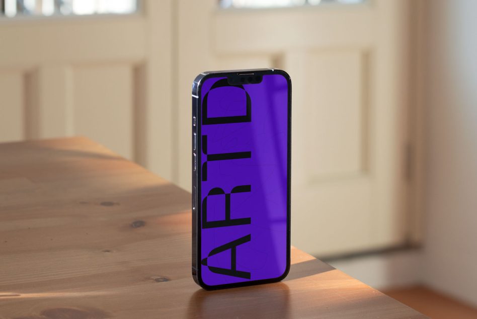 Smartphone mockup on wooden table showcasing screen design. Realistic mobile presentation for apps, wallpapers, and interfaces in a natural setting.