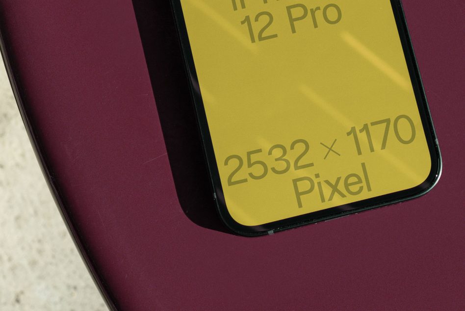 Yellow iPhone 12 Pro screen mockup with gold text on burgundy backdrop
