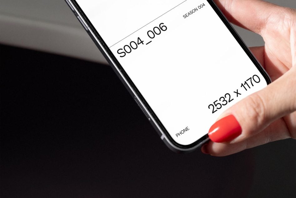 Hand holding phone displaying season 004 mockup at 2532 x 1170 pixel dimensions