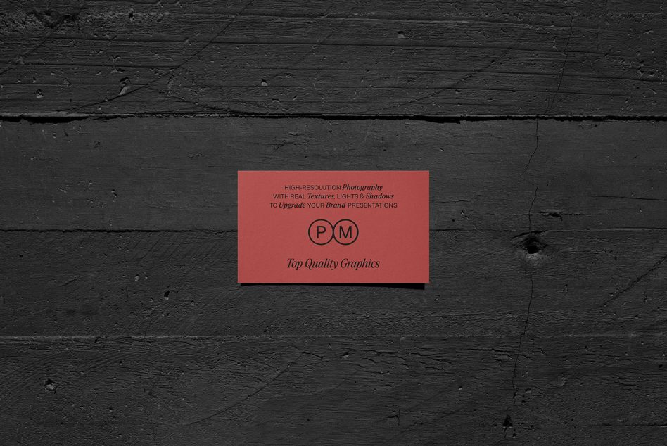 Coral red business card mockup on dark wooden surface