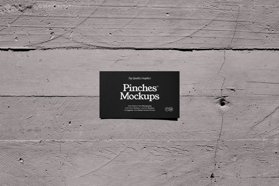 Black business card centered on distressed whitewashed wooden surface