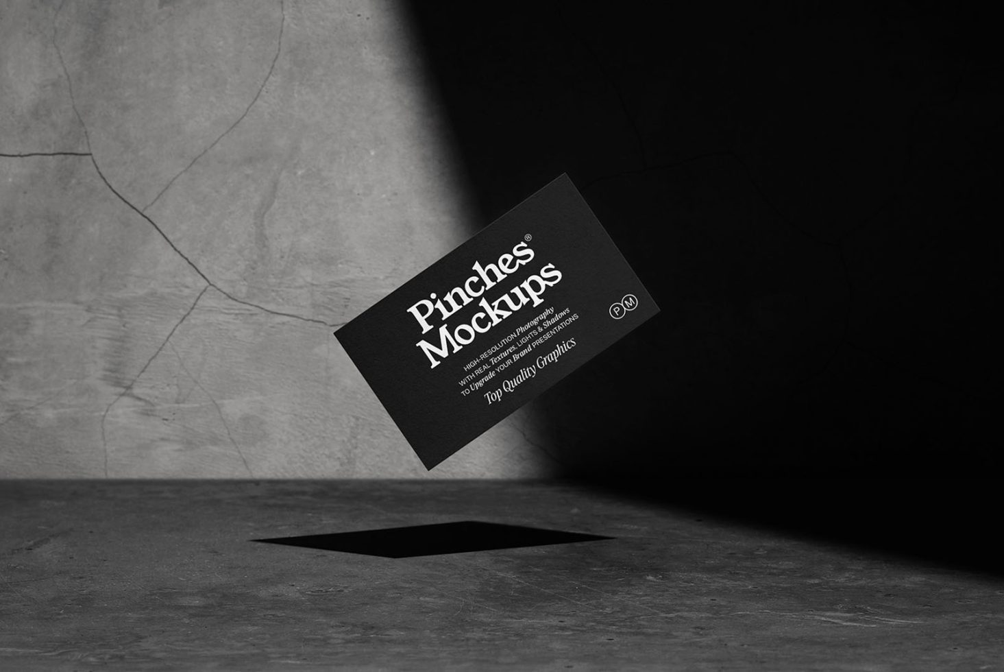 Elegant black business card mockup with white text on a textured concrete background, ideal for presentation in design portfolios.