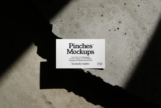 Business card mockup on textured concrete with dynamic shadows for realistic design presentation, perfect for designers, high-resolution graphic display.