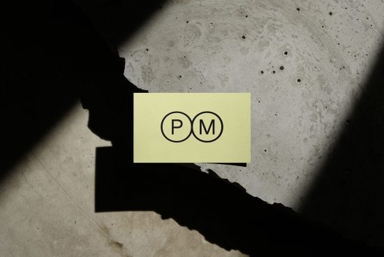 Business card mockup with logo shadow on concrete texture for graphic design presentation and portfolio display.