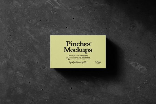 Business card mockup on a dark textured background featuring realistic shadows and a modern design, perfect for professional branding presentations.