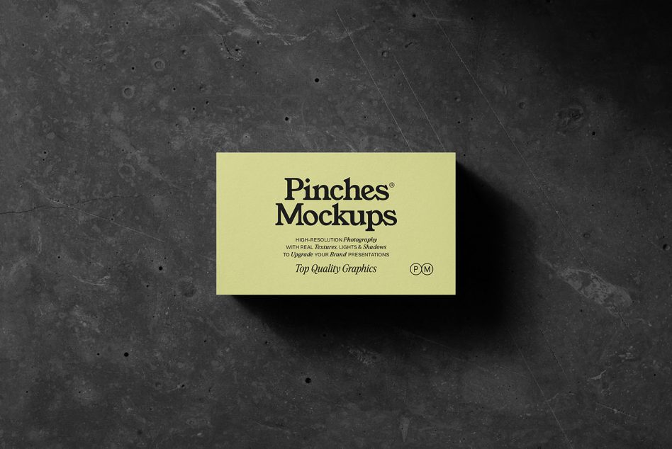 Yellow business card mockup on dark concrete with realistic shadows